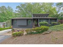 Contemporary home with modern design elements and mature landscaping at 3165 Brookview Dr, Marietta, GA 30068