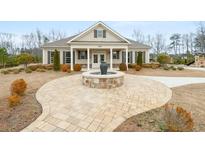 Charming single-story home with a welcoming front yard and beautiful water feature at 7575 Old Camp Lndg, Cumming, GA 30040