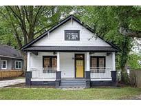 Charming exterior view of a two-story home featuring a welcoming front porch and a bright yellow front door at 1120 Arlington Sw Ave, Atlanta, GA 30310