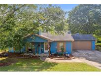 Charming blue single story home with a cozy front porch and manicured front yard at 483 Glen Terrace Rd, Auburn, GA 30011