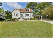 Charming single-Gathering home featuring classic architecture, well-manicured lawn, and a convenient covered carport at 1972 Wingate Rd, Chamblee, GA 30341