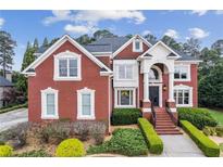 Beautiful red brick two-story home with manicured landscaping and a grand entrance at 3364 Kylee Dawn Cir, Lawrenceville, GA 30045