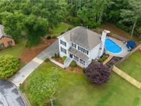 Stunning aerial view of a home featuring a beautiful pool and well-maintained landscaping at 1482 Pinebark Ct., Grayson, GA 30017