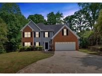 Charming two-story home with brick and siding, black shutters, and a well-manicured lawn at 5705 Cannonero Dr, Alpharetta, GA 30005