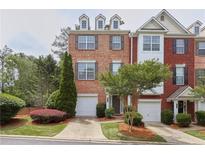 Charming brick townhome with attached garage, manicured landscaping, and inviting curb appeal at 7812 Kiverton Pl, Atlanta, GA 30350