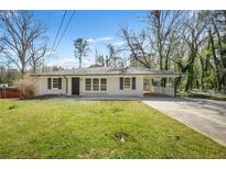 Charming single-story home featuring a covered carport and well-maintained lawn at 2703 Flagstone Se Dr, Atlanta, GA 30316