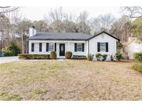 Charming single-story home featuring classic curb appeal, manicured bushes, and dark shutters at 2172 Red Rose Ln, Loganville, GA 30052