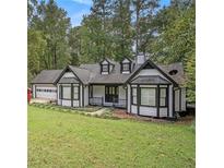 Charming two-story home with white siding, black trim, and a well-manicured front yard at 4902 Cedar Se Ct, Conyers, GA 30094