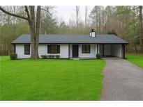 Charming one-story home with a well-manicured front yard and a covered carport at 3436 Lake Monroe Rd, Douglasville, GA 30135