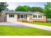 Charming ranch-style home featuring a brick facade, well-manicured lawn, and inviting curb appeal at 4529 Lakeview Dr, Powder Springs, GA 30127