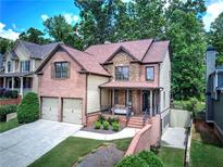 Beautiful two-story home with brick and stone accents, two-car garage, and charming front porch at 233 Yorkshire Ln, Villa Rica, GA 30180