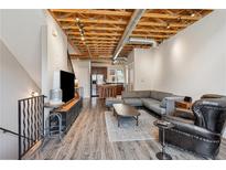 Open living room with exposed wood ceiling, modern furnishings, and seamless flow to the kitchen at 322 Peters Sw St # 6, Atlanta, GA 30313