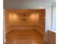 Bright dining room with hardwood floors, chandelier, and decorative molding at 2734 Peachtree Nw Rd # B402, Atlanta, GA 30305