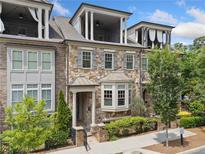 Charming townhome with stone facade, bay window, and inviting balconies offering stylish outdoor living spaces at 1112 Cordia Nw Ave, Atlanta, GA 30318