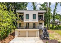Contemporary two-story home with a front-facing two-car garage and steel staircase at 240 Patterson Se Ave, Atlanta, GA 30316