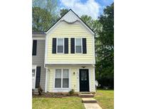 Charming two-story home with a yellow facade and black shutters, complemented by a well-maintained front lawn at 458 Prince Of Wales, Stone Mountain, GA 30083
