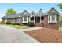 Charming brick home with a well-manicured front yard and inviting front porch at 8117 Spivey Rd, Jonesboro, GA 30236