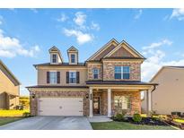 Beautiful brick and siding two-story home with a two-car garage and well-manicured lawn at 109 Logan Pass Dr, Loganville, GA 30052