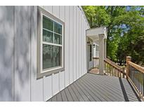Lovely front porch with wood decking and railing offering views of the lush greenery and entryway at 313 Yancy Se Dr, Marietta, GA 30067
