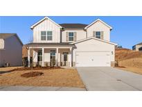 Charming two-story home features a covered front porch, a two car garage and professionally landscaped yard at 5587 Rosehall Pl, Atlanta, GA 30349