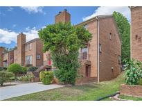 Charming brick townhouse with well-maintained landscaping and inviting entrance, perfect for comfortable living at 91 Davis Mill Ct, Lawrenceville, GA 30044
