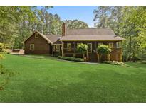 Charming single-Gathering home with a lush green lawn and inviting front porch at 4615 Gresham Rd, Douglasville, GA 30134