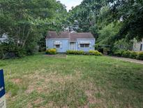 Charming blue home with mature landscaping and a welcoming front yard at 2355 Hillside Ave, Decatur, GA 30032