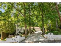 Charming two-story home with a manicured lawn and mature trees providing ample shade at 3307 Pointe Bleue Ct, Decatur, GA 30034