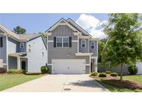 Charming two-story home with gray siding, a two-car garage, and well-maintained landscaping at 156 Woodhouse Cir, Acworth, GA 30102