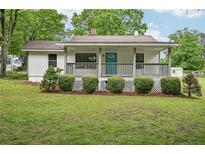 Charming single-story home with a welcoming front porch and well-maintained lawn at 6648 Florence Dr, Lithia Springs, GA 30122