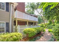 View of backyard deck with white railing and lush greenery, enhancing the property's outdoor appeal at 1750 Clairmont Rd # 32, Decatur, GA 30033