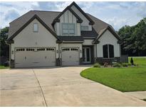 Charming two-story home featuring a three car garage, manicured lawn, and craftsman style architecture at 3000 Keeneland Blvd, Mcdonough, GA 30252