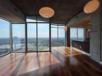 Bright living room featuring hardwood floors, floor to ceiling windows and spectacular views at 3324 Peachtree Ne Rd # 3001, Atlanta, GA 30326