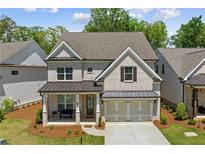Charming two-story brick home with a covered porch and manicured landscaping at 1589 Bennett Creek Overlook, Suwanee, GA 30024