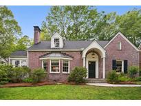 Charming red brick two-story home with manicured lawn and beautiful landscaping at 2672 Birchwood Dr, Atlanta, GA 30305