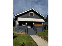 Charming home with dark exterior, covered porch, and walkway leading to a welcoming entrance at 1286 Allene Sw Ave, Atlanta, GA 30310