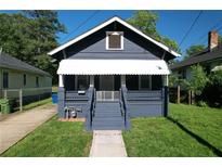 Charming one-story home with blue siding, covered porch, and well-maintained front lawn at 1286 Allene Sw Ave, Atlanta, GA 30310
