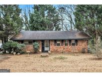 Charming single-story brick home with a well-maintained front yard and mature trees at 1491 Boulderwoods Dr, Atlanta, GA 30316