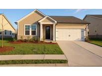 Beautiful single-story home with a well-maintained lawn and attached two car garage at 1783 Juniper Berry Way, Loganville, GA 30052