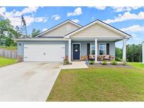 Charming single-story home boasts a two-car garage, inviting front porch, and well-manicured lawn at 99 Oxford Ln, Kingston, GA 30145
