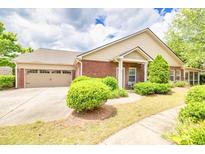 Charming brick home with a two-car garage and a well-manicured lawn, perfect for curb appeal at 2318 Chancery Mill Ln, Buford, GA 30519