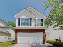 Charming two-story home featuring brick accents and a well-maintained front yard at 2429 Wood Bend Ln, Riverdale, GA 30296