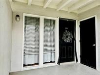 Charming entryway with a black front door and decorative wreath, adjacent to bright windows at 1150 Collier Nw Rd # 25D, Atlanta, GA 30318