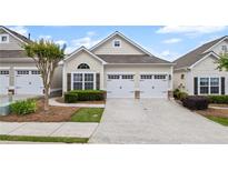 Charming cottage-style home with a well-manicured front yard and a two-car garage at 329 Acuba Vw, Woodstock, GA 30188