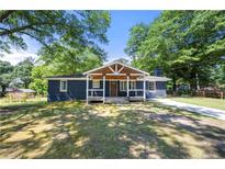 Charming home featuring a covered porch and well-maintained lawn at 3770 Ponderosa Ln, Powder Springs, GA 30127