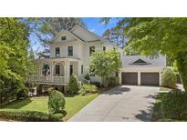 Charming two-story home with a welcoming front porch and manicured landscaping at 4495 Westgate Dr, Cumming, GA 30040