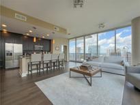 Open-concept living room and kitchen with floor-to-ceiling windows and modern finishes at 1080 Ne Peachtree Ne St # 2802, Atlanta, GA 30309