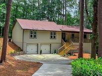 Charming ranch-style home featuring a two-car garage, stone accents, and a welcoming front porch at 641 Charing Cross Dr, Marietta, GA 30066