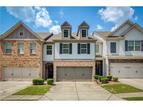 Charming townhome with brick accents, attached garages, and a well-maintained lawn at 2249 Knoxhill Se Vw, Smyrna, GA 30082