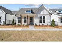 Charming single-story home featuring a board and batten siding and a welcoming entry with a blue door at 517 Godfrey Dr, Cumming, GA 30040